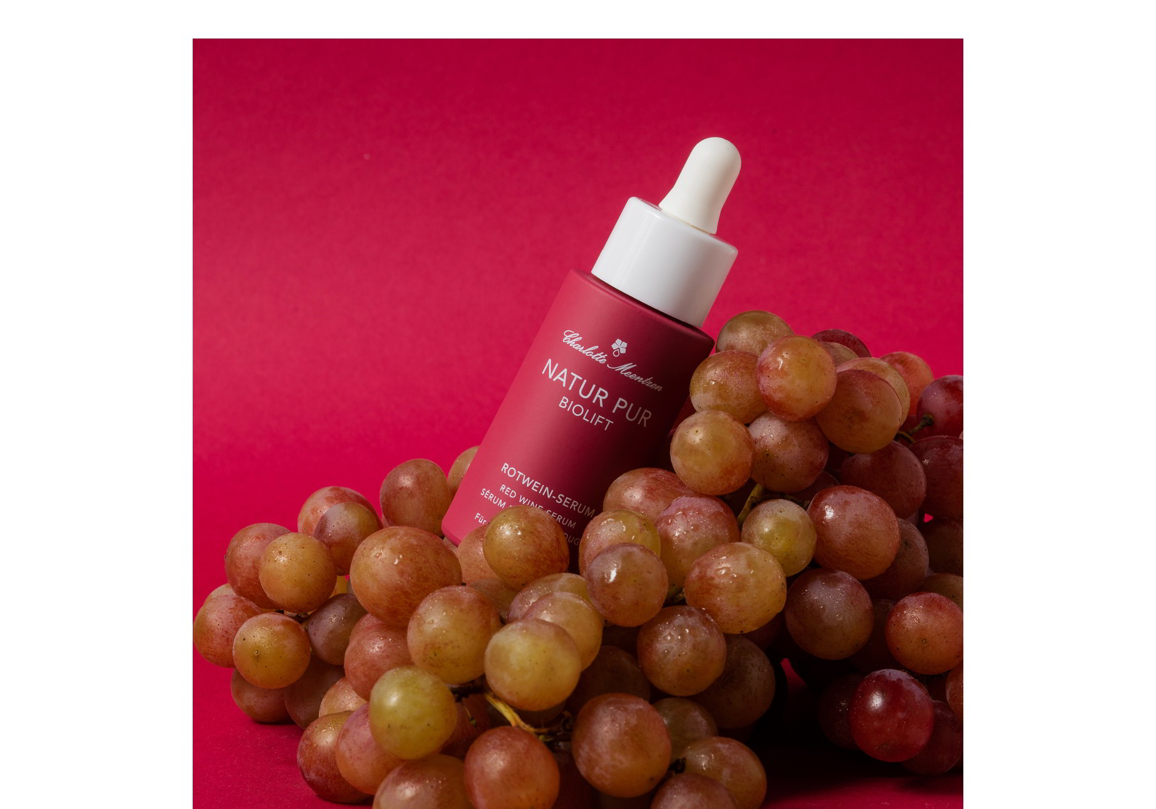 Natur Pur BIOLIFT Rotwein-Serum auf Weintrauben vor rotem Hintergund